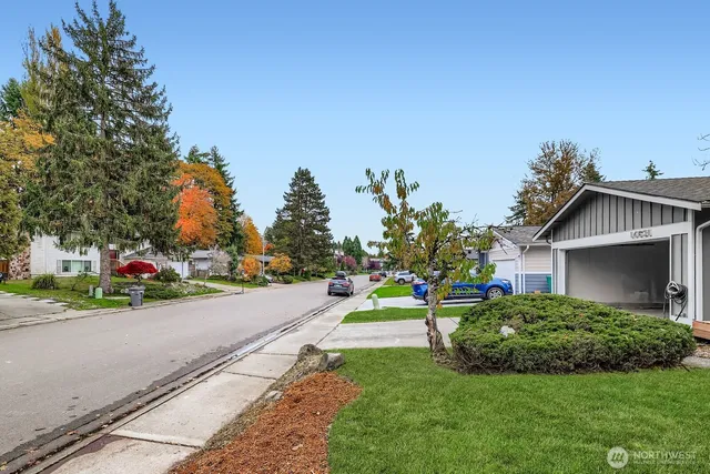 a view of a house with a yard and sitting area