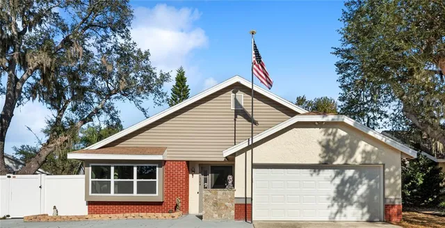 a view of house with a tree beside it