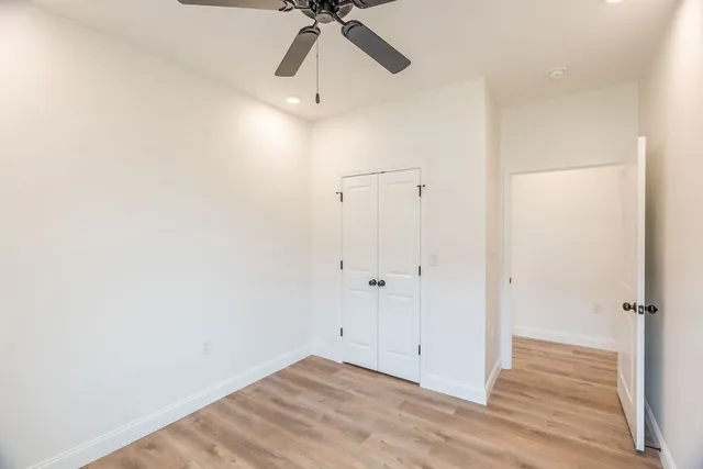 a view of a room with wooden floor