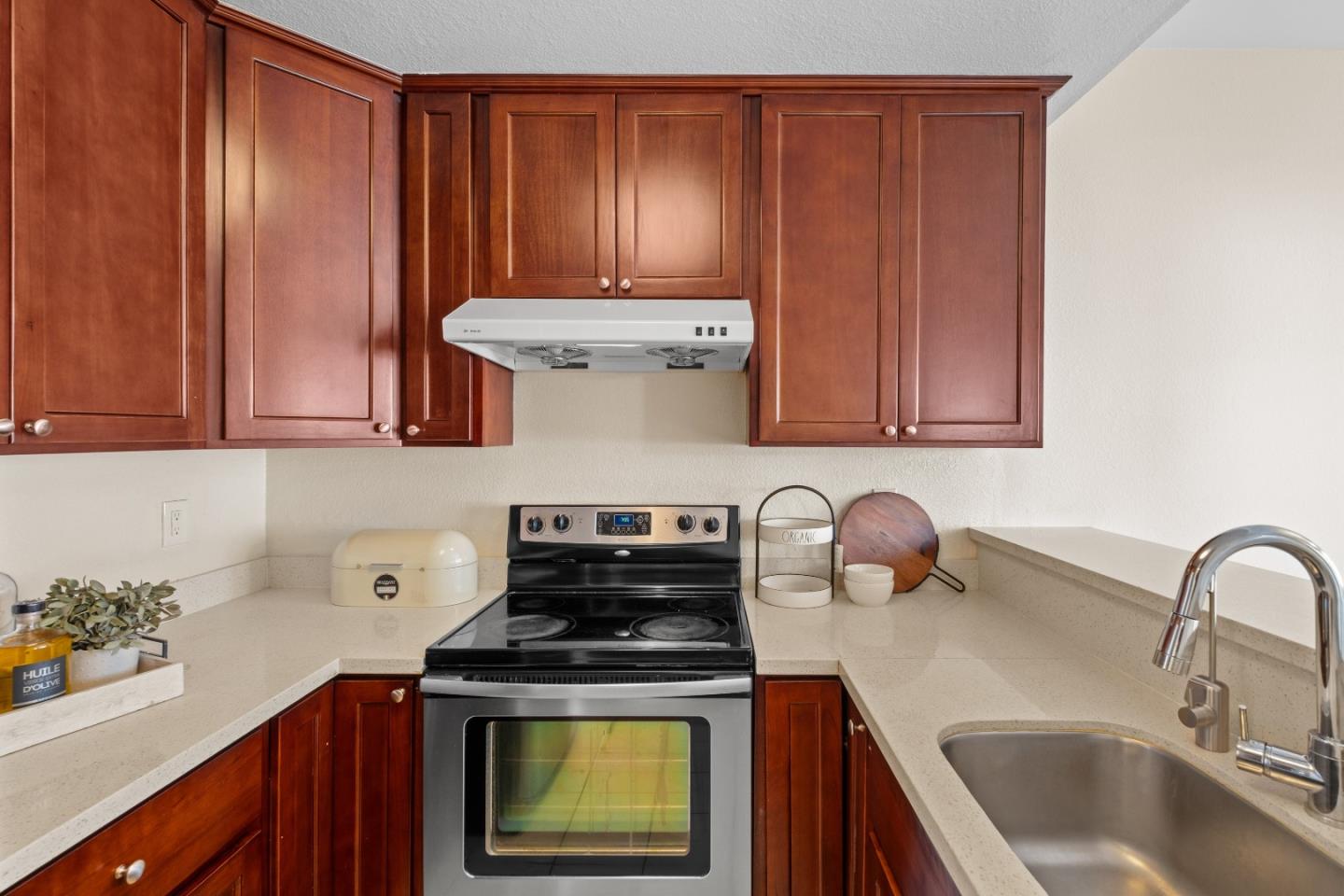 1392 Meadow Ridge Circle San Jose, CA 95131 - Photo 16 of 43 a kitchen with stainless steel appliances granite countertop a sink stove and cabinets