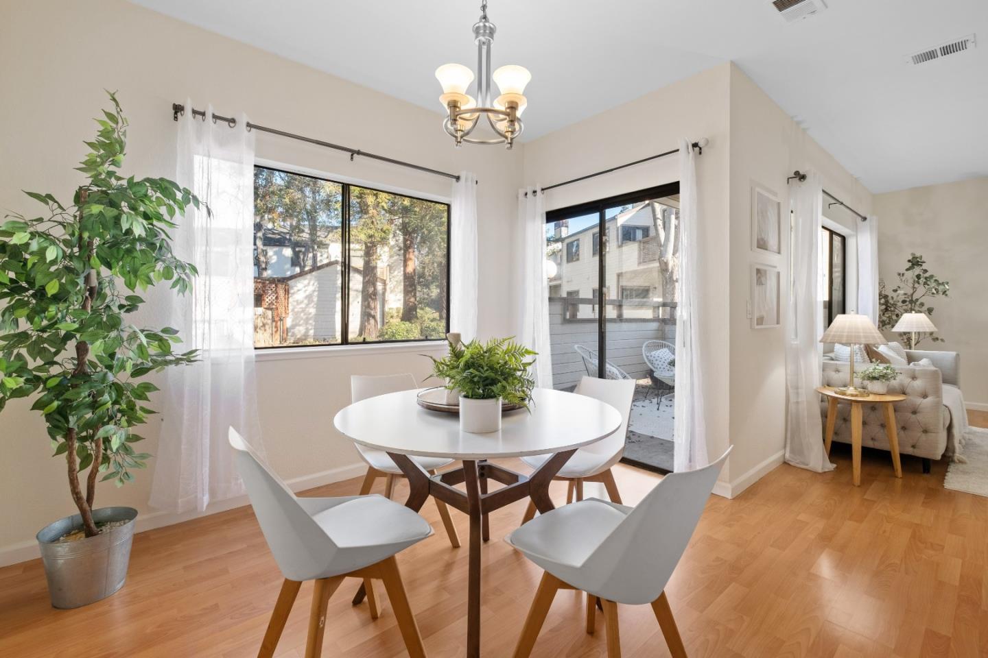 1392 Meadow Ridge Circle San Jose, CA 95131 - Photo 10 of 43 a dining room with furniture potted plants and wooden floor