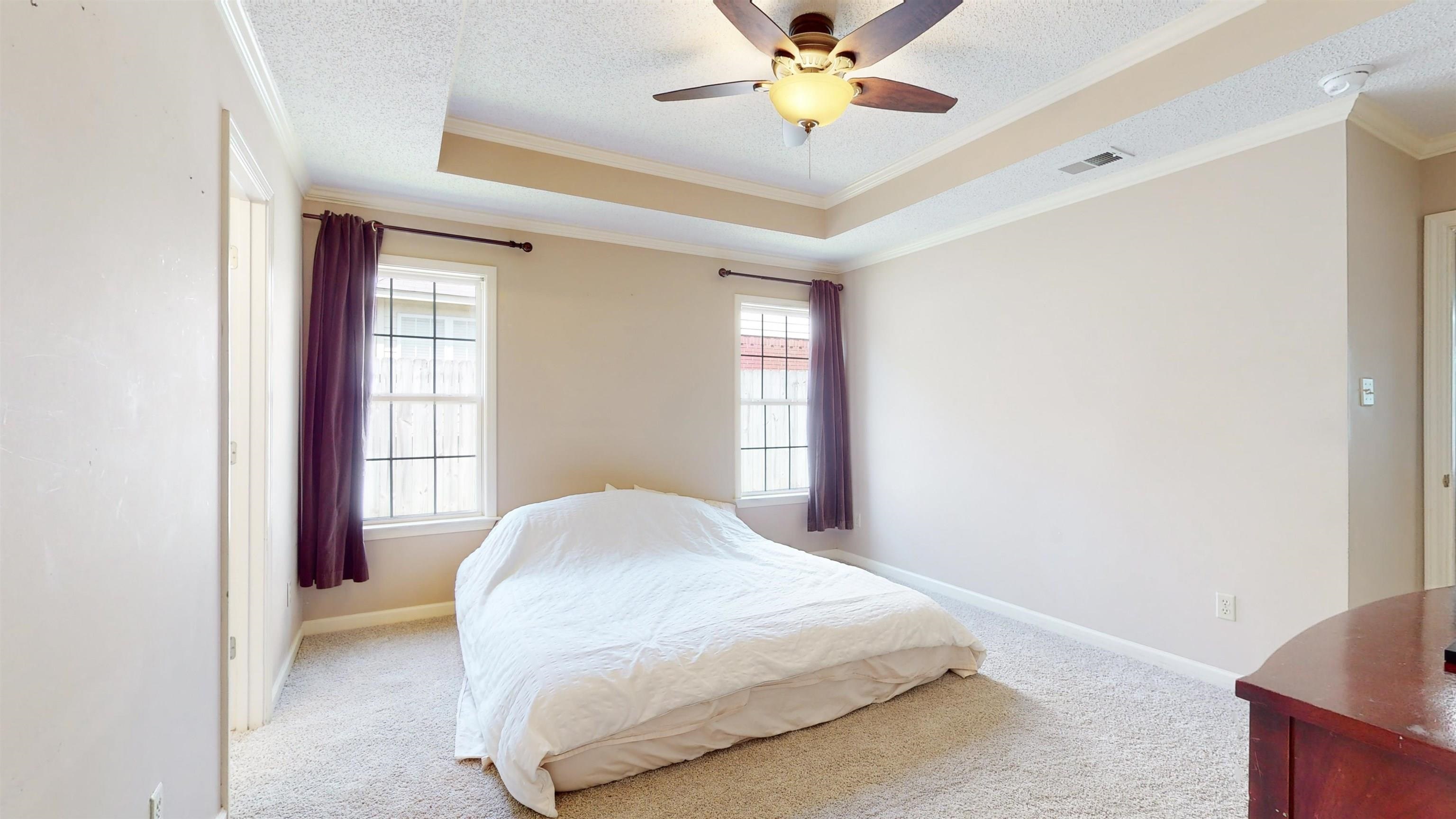 195 Cross Point Drive Collierville, TN 38017 - Photo 6 of 11 a bedroom with a bed and a chandelier