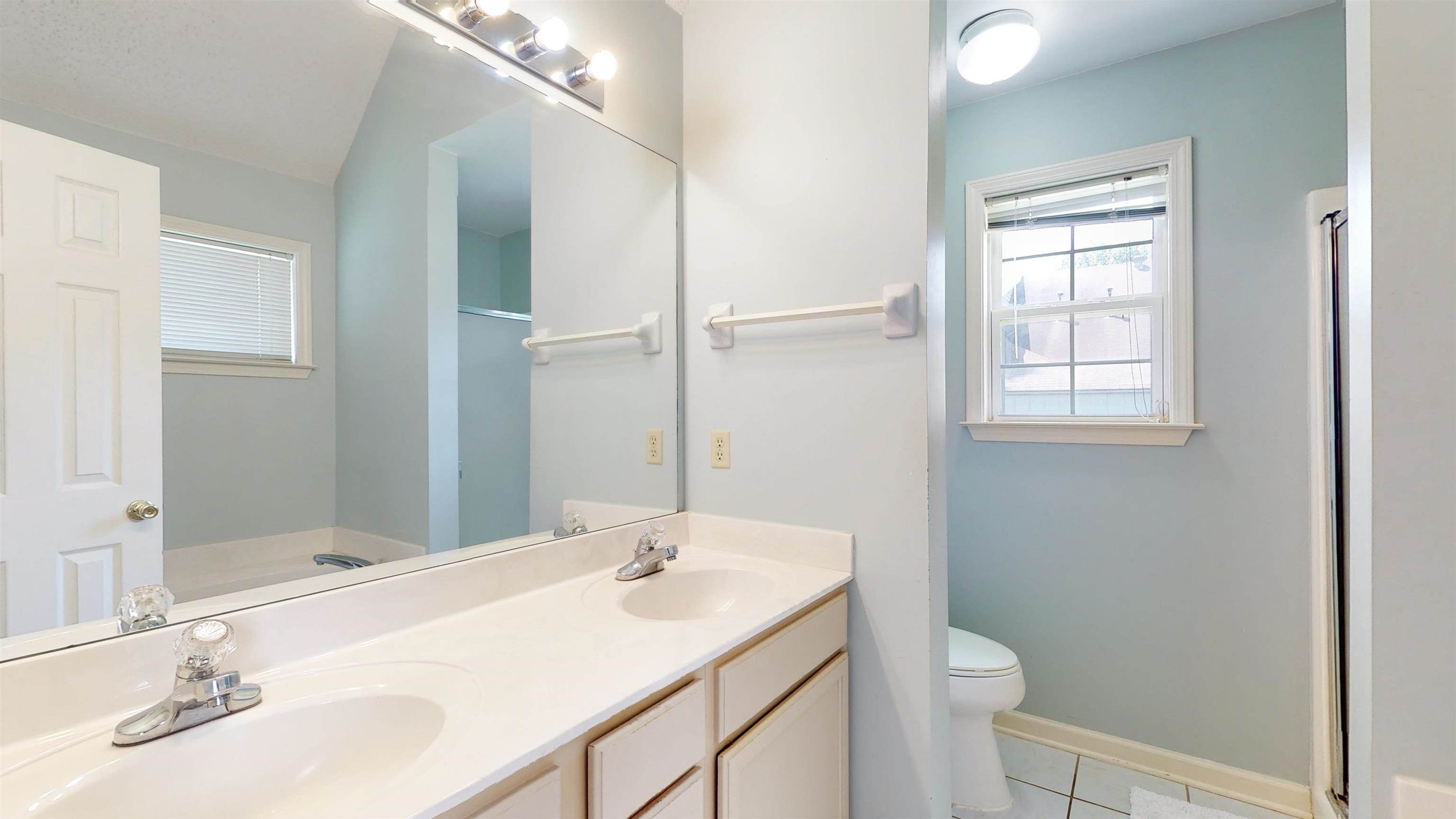 195 Cross Point Drive Collierville, TN 38017 - Photo 7 of 11 a bathroom with a sink toilet and vanity