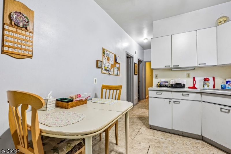 50 Preston Street Ridgefield Park, NJ 07660 - Photo 14 of 41 a kitchen with stainless steel appliances granite countertop a table chairs and a refrigerator