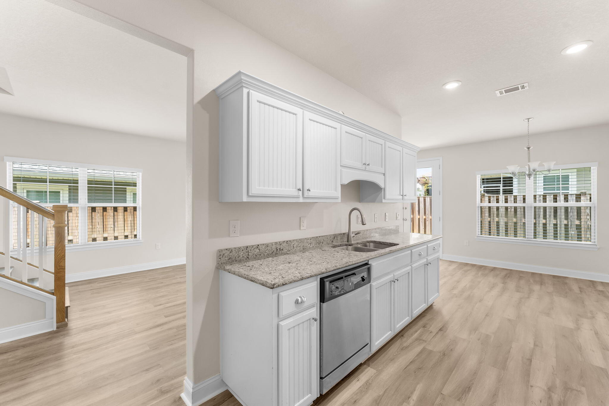 120 Brandywine Road Freeport, FL 32439 - Photo 14 of 29 a kitchen with stainless steel appliances granite countertop a stove a sink and white cabinets with wooden floor