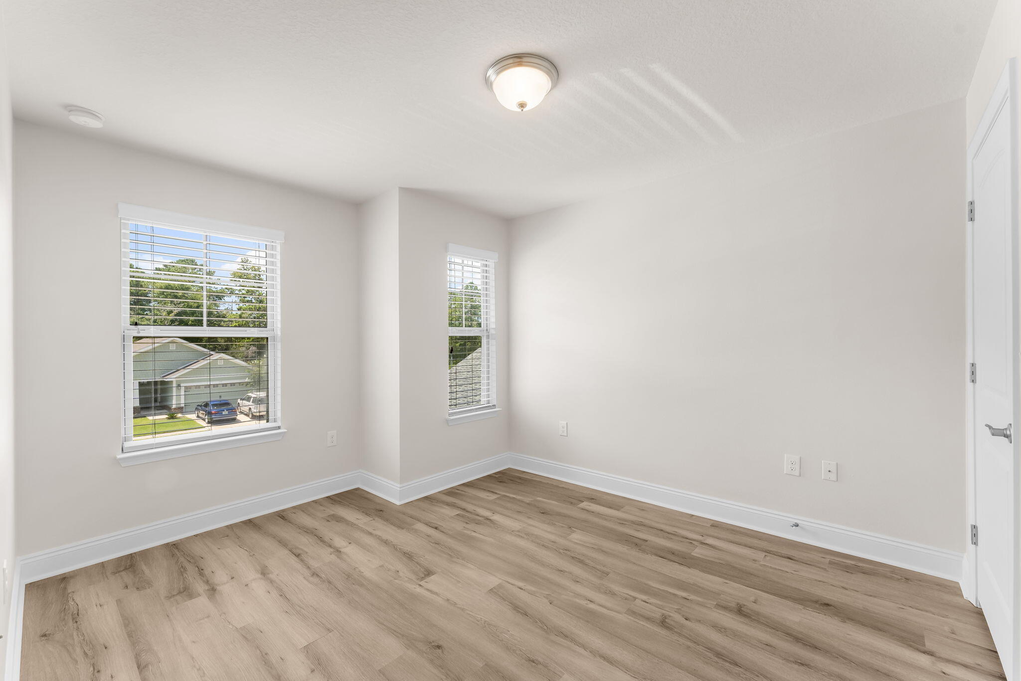 120 Brandywine Road Freeport, FL 32439 - Photo 17 of 29 an empty room with wooden floor and windows