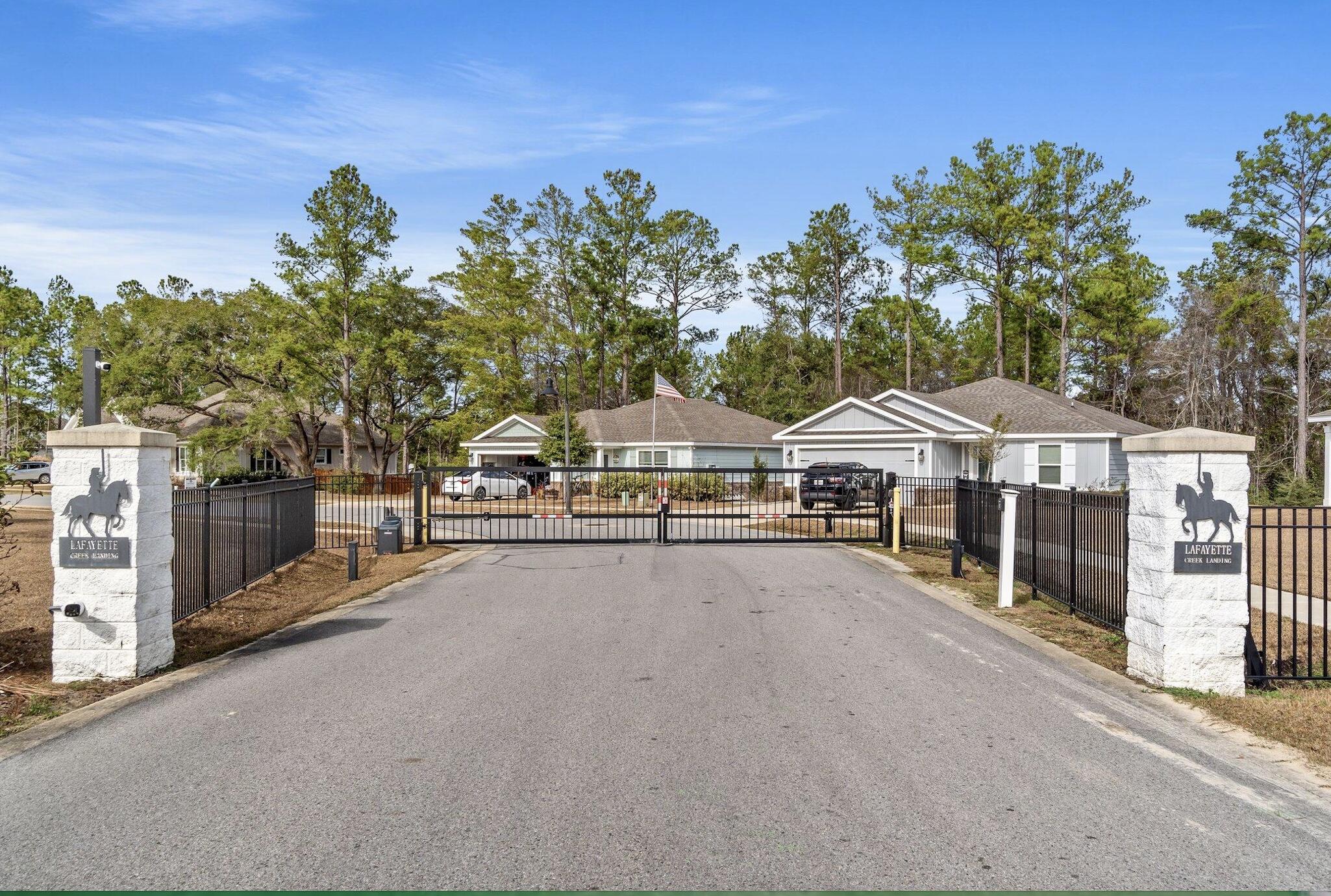 120 Brandywine Road Freeport, FL 32439 - Photo 2 of 29 a view of a white house with a big yard and large trees