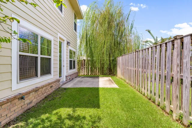 a view of yard with small cabin and wooden floor