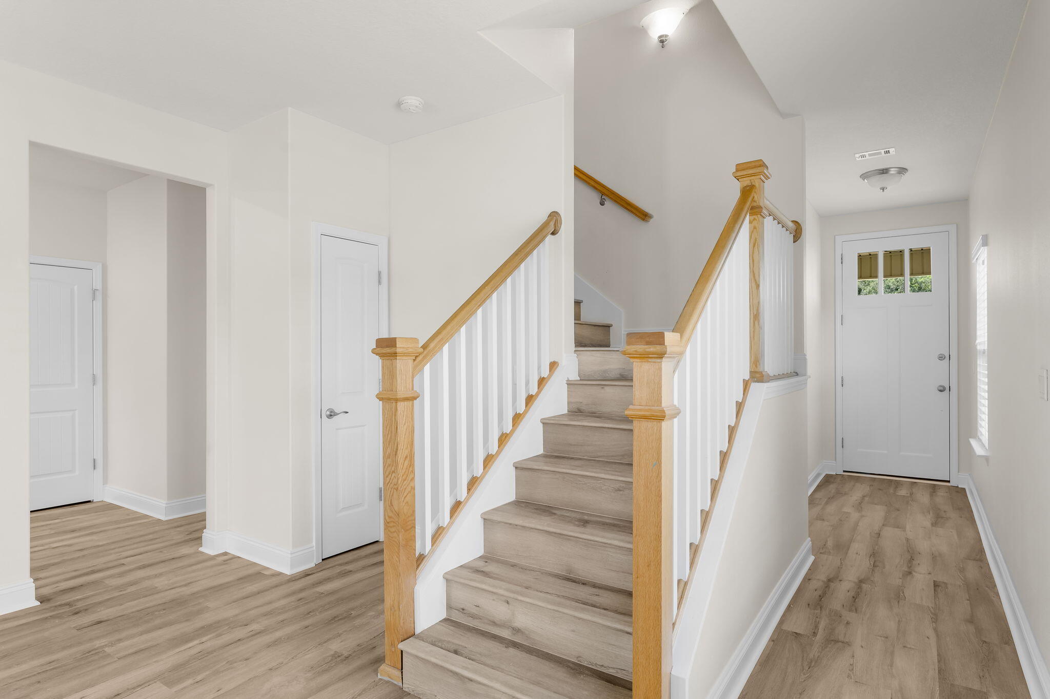 120 Brandywine Road Freeport, FL 32439 - Photo 6 of 29 a view of a hallway with wooden floor and staircase