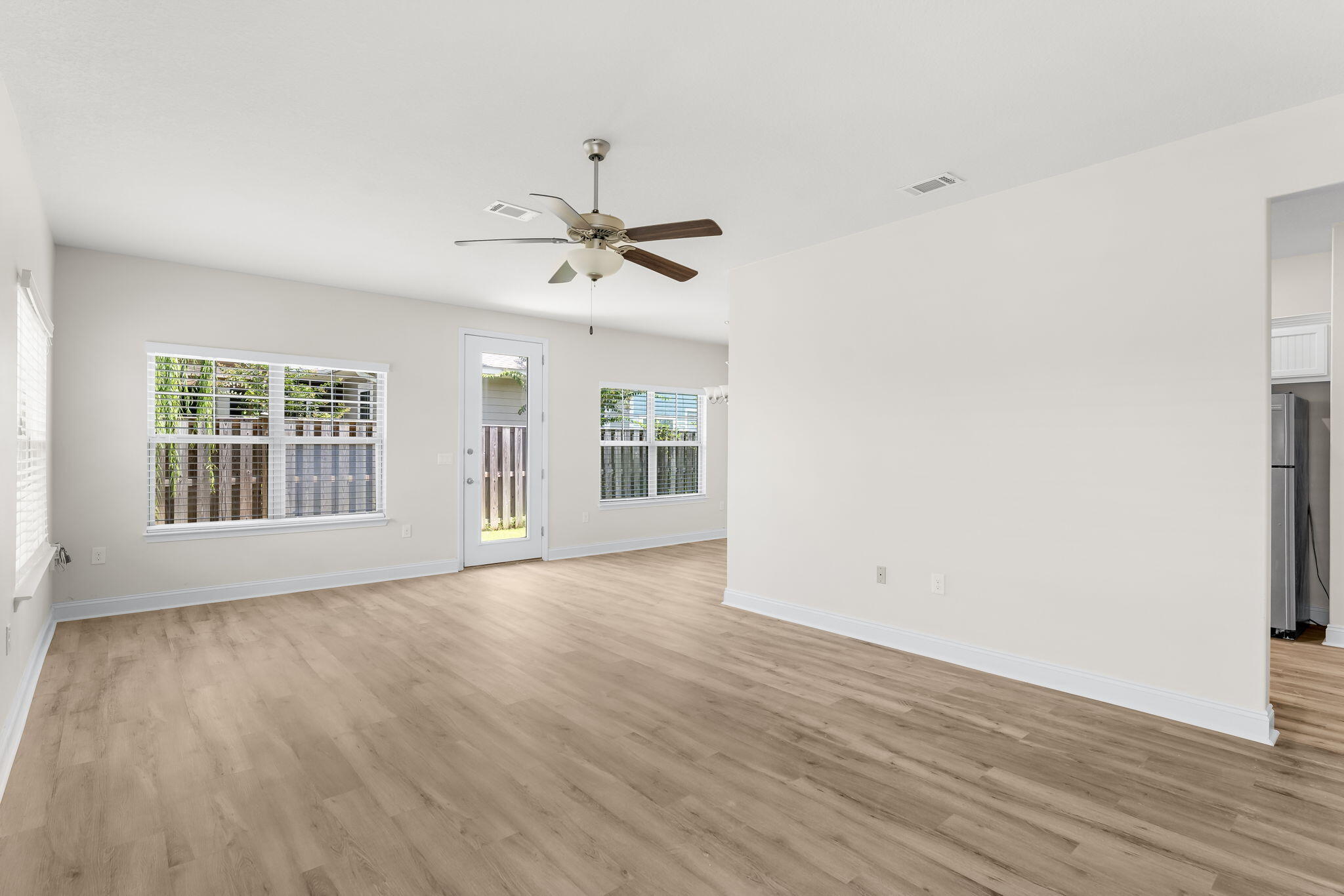 120 Brandywine Road Freeport, FL 32439 - Photo 7 of 29 a view of an empty room with wooden floor and a window