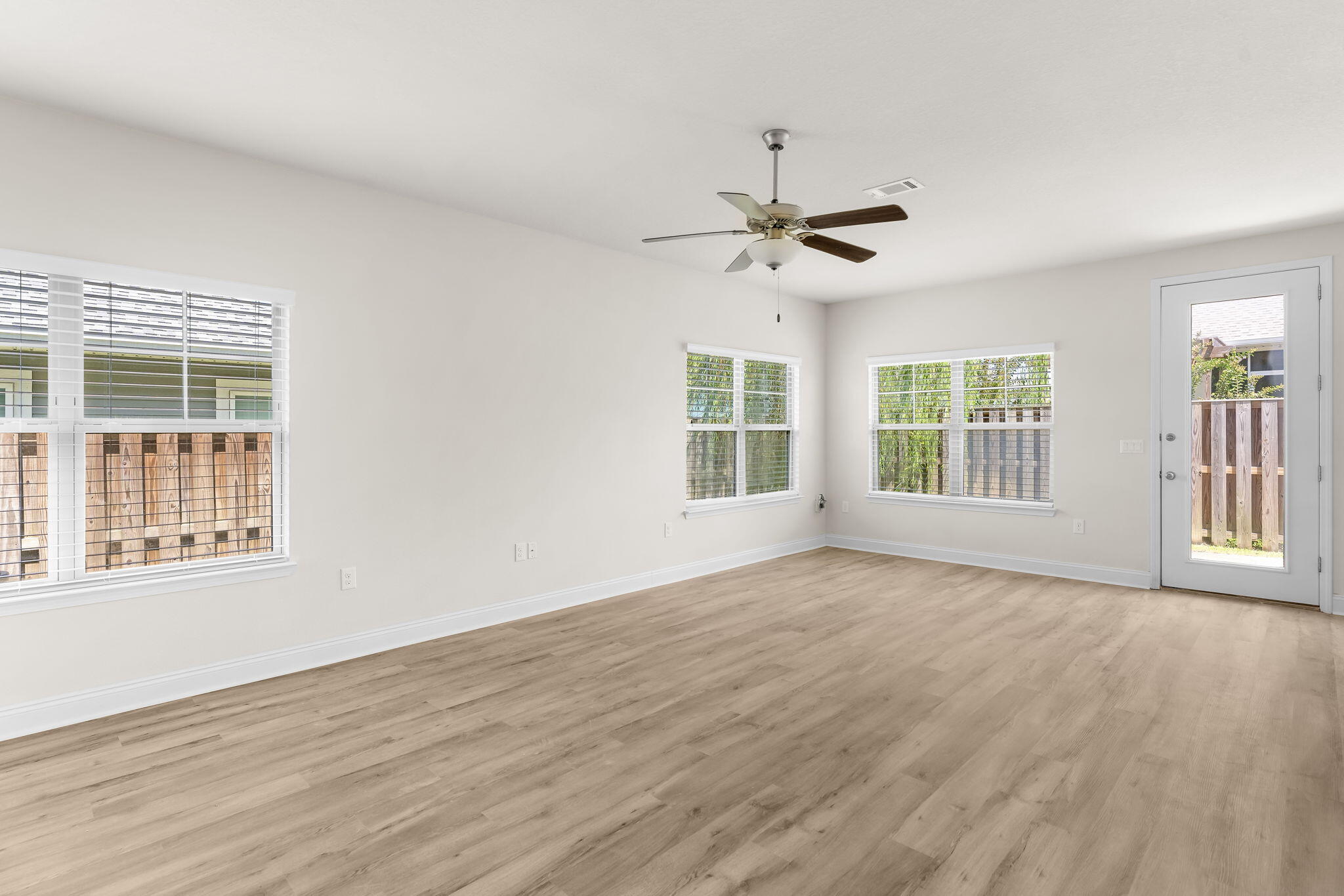 120 Brandywine Road Freeport, FL 32439 - Photo 8 of 29 a view of an empty room with a window and wooden floor