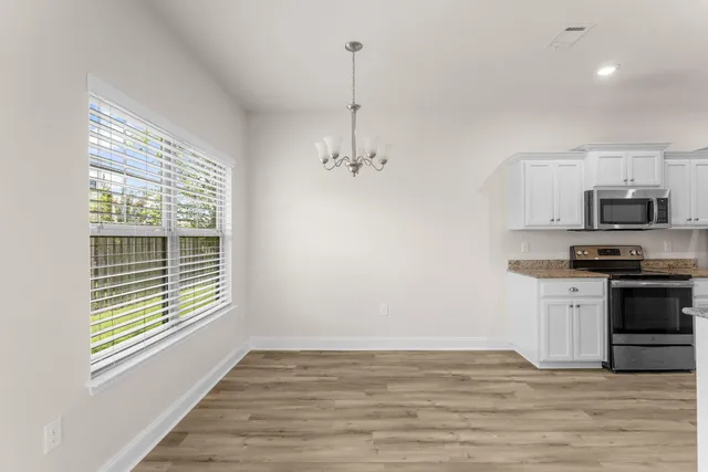 a view of a kitchen with microwave and stove top oven