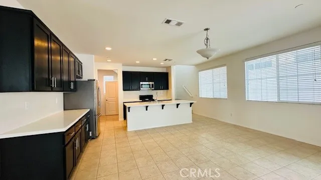 a large white kitchen with a large counter top appliances and cabinets