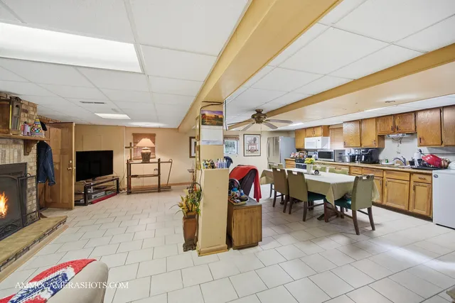 a living room with lots of furniture and kitchen view
