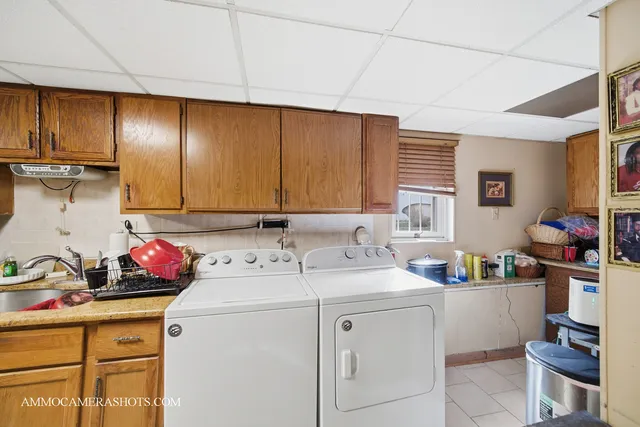 a utility room with sink dryer and washer