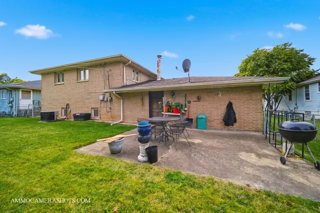 a view of a house with a yard and sitting area
