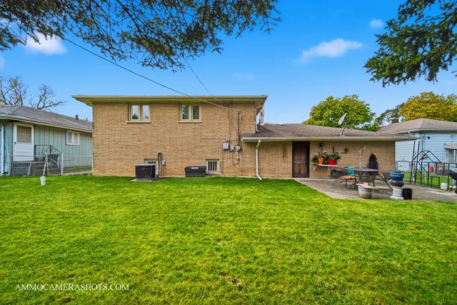 a front view of a house with patio and garden