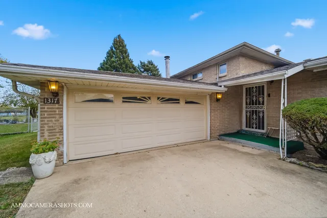 a view of a house with a small yard and plants