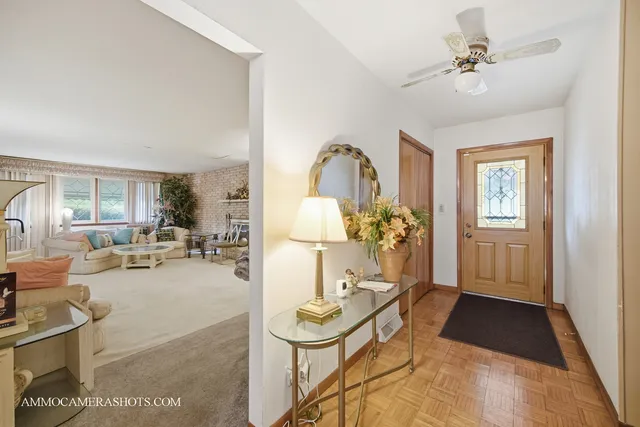 a living room with furniture a chandelier and a table