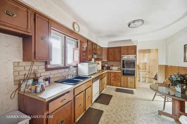 a kitchen with a sink stove and refrigerator