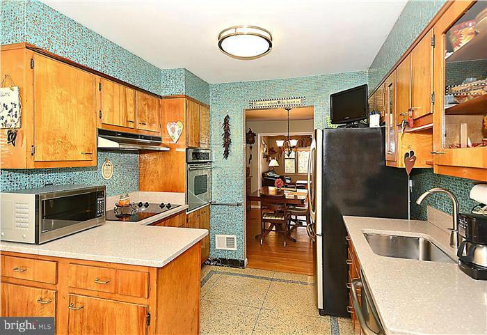 10804 Margate Road Silver Spring, MD 20901 - Photo 12 of 30 a kitchen that has a microwave a stove and a refrigerator