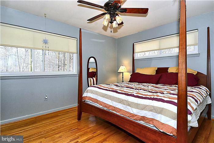 10804 Margate Road Silver Spring, MD 20901 - Photo 13 of 30 a bedroom with a bed and a chandelier