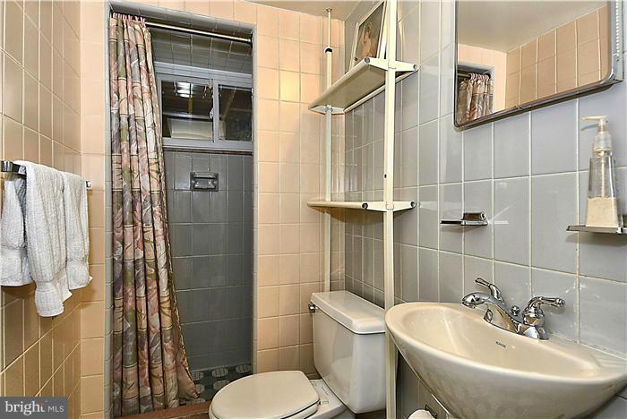 10804 Margate Road Silver Spring, MD 20901 - Photo 24 of 30 a bathroom with a sink toilet and shower