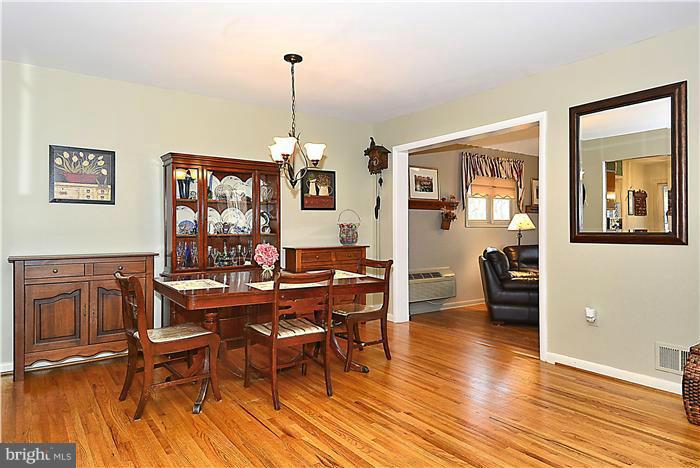 10804 Margate Road Silver Spring, MD 20901 - Photo 7 of 30 a view of a livingroom with furniture a rug wooden floor and a chandelier