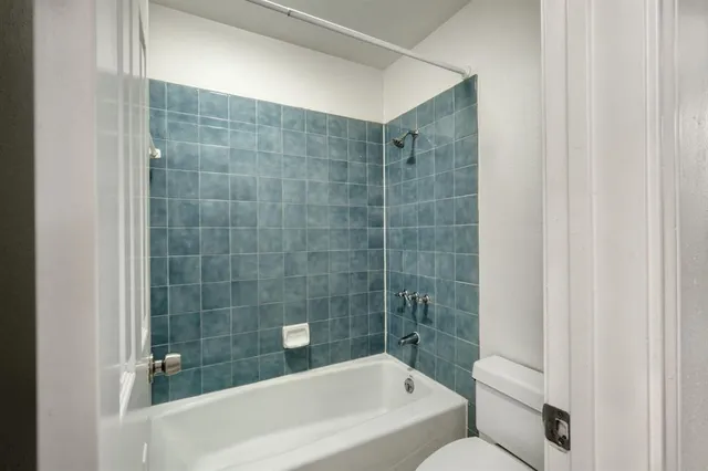 a bathroom with a bathtub and shower