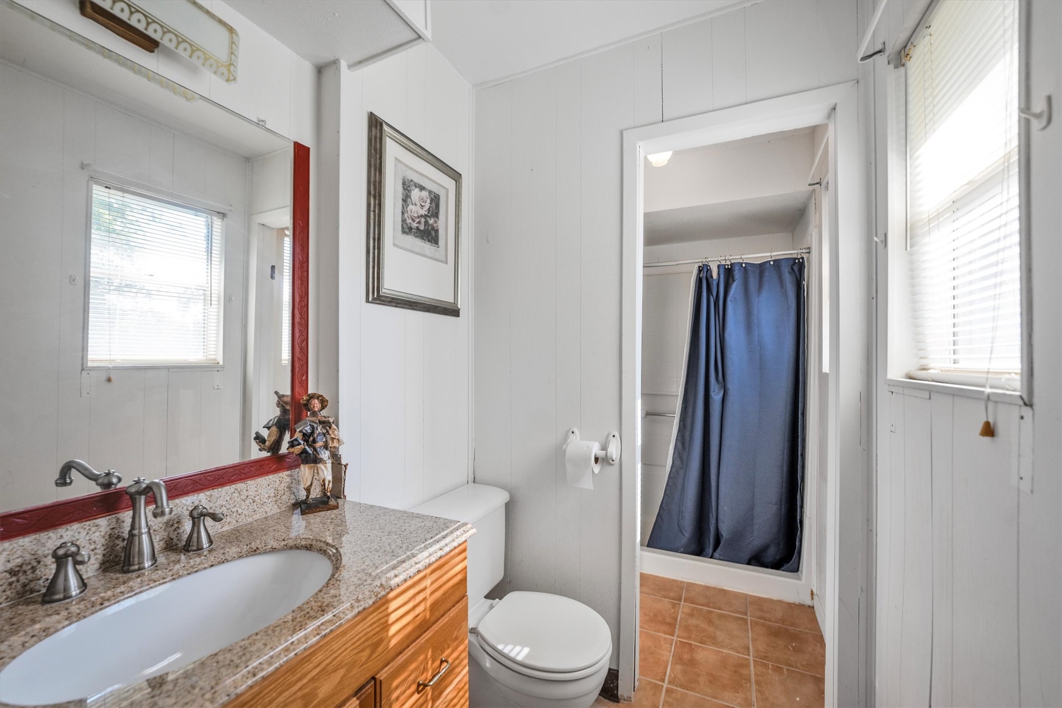 18111 Roy Long Road Pearland, TX 77584 - Photo 21 of 36 Bright and functional with a granite-topped vanity, framed mirror, and plenty of natural light for a fresh morning routine.