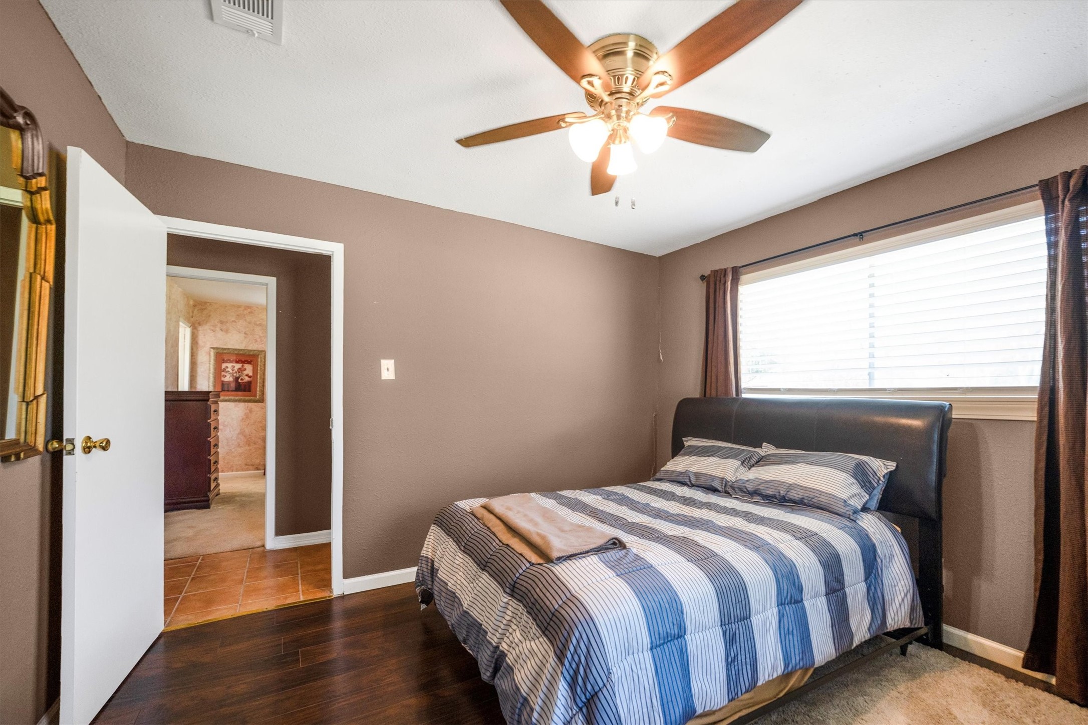 18111 Roy Long Road Pearland, TX 77584 - Photo 24 of 36 This comfortable guest bedroom offers a relaxing atmosphere with warm tones, natural light, and cozy finishes.