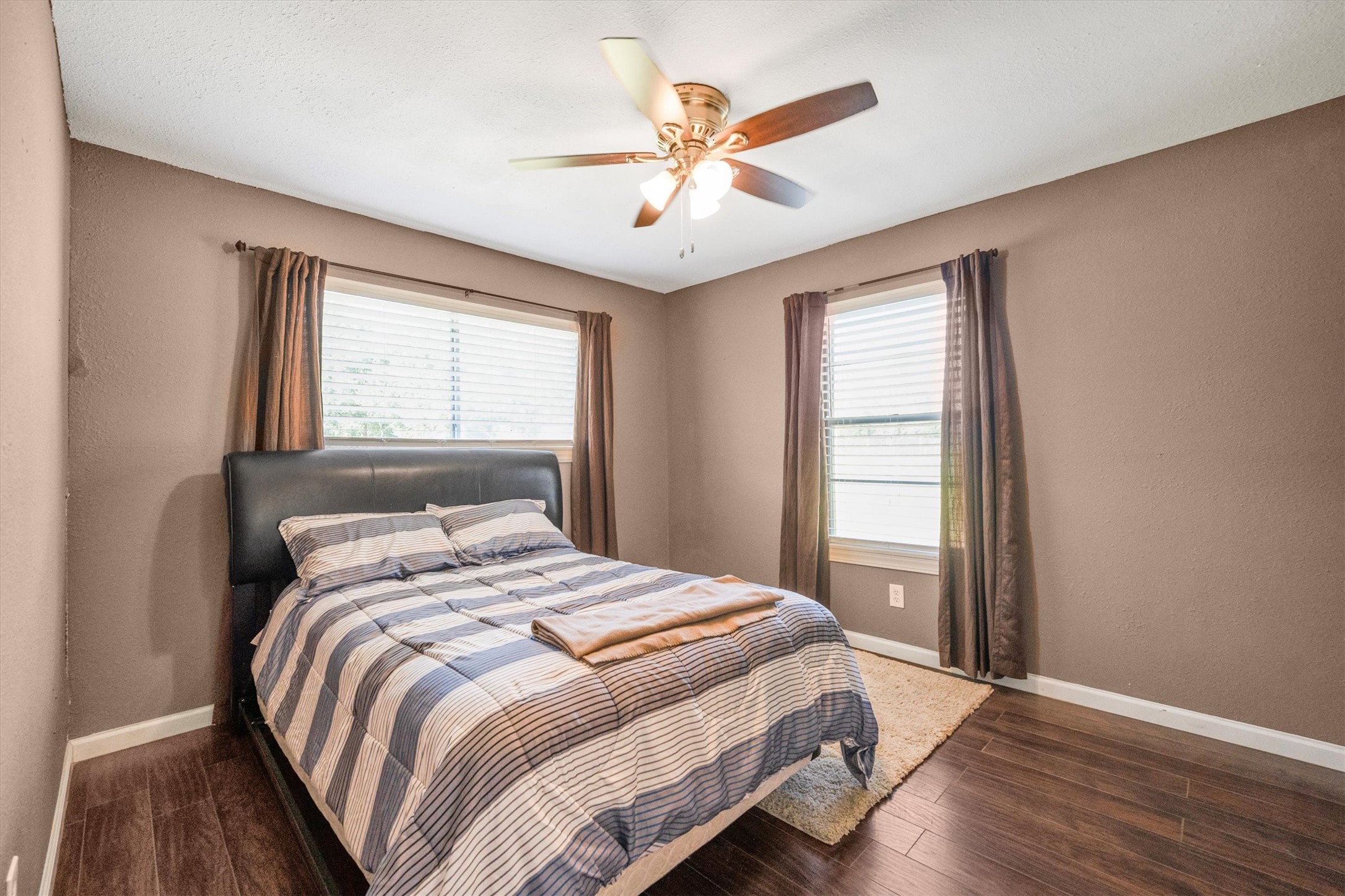 18111 Roy Long Road Pearland, TX 77584 - Photo 25 of 36 Ample windows and rich flooring make this space bright and welcoming—ideal for guests, an office, or a peaceful retreat.