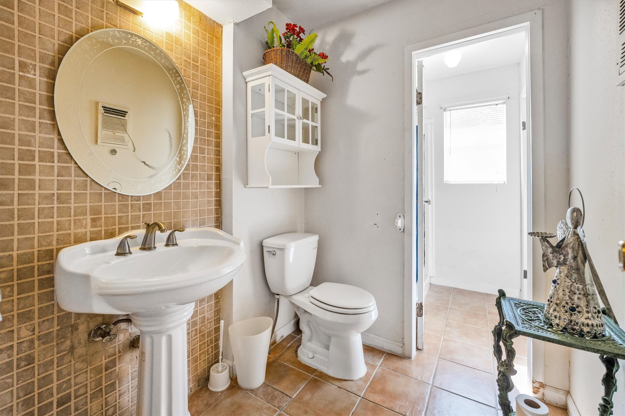 18111 Roy Long Road Pearland, TX 77584 - Photo 26 of 36 Charming and functional with a pedestal sink, decorative mirror, and soft tile tones that give the space a timeless touch.