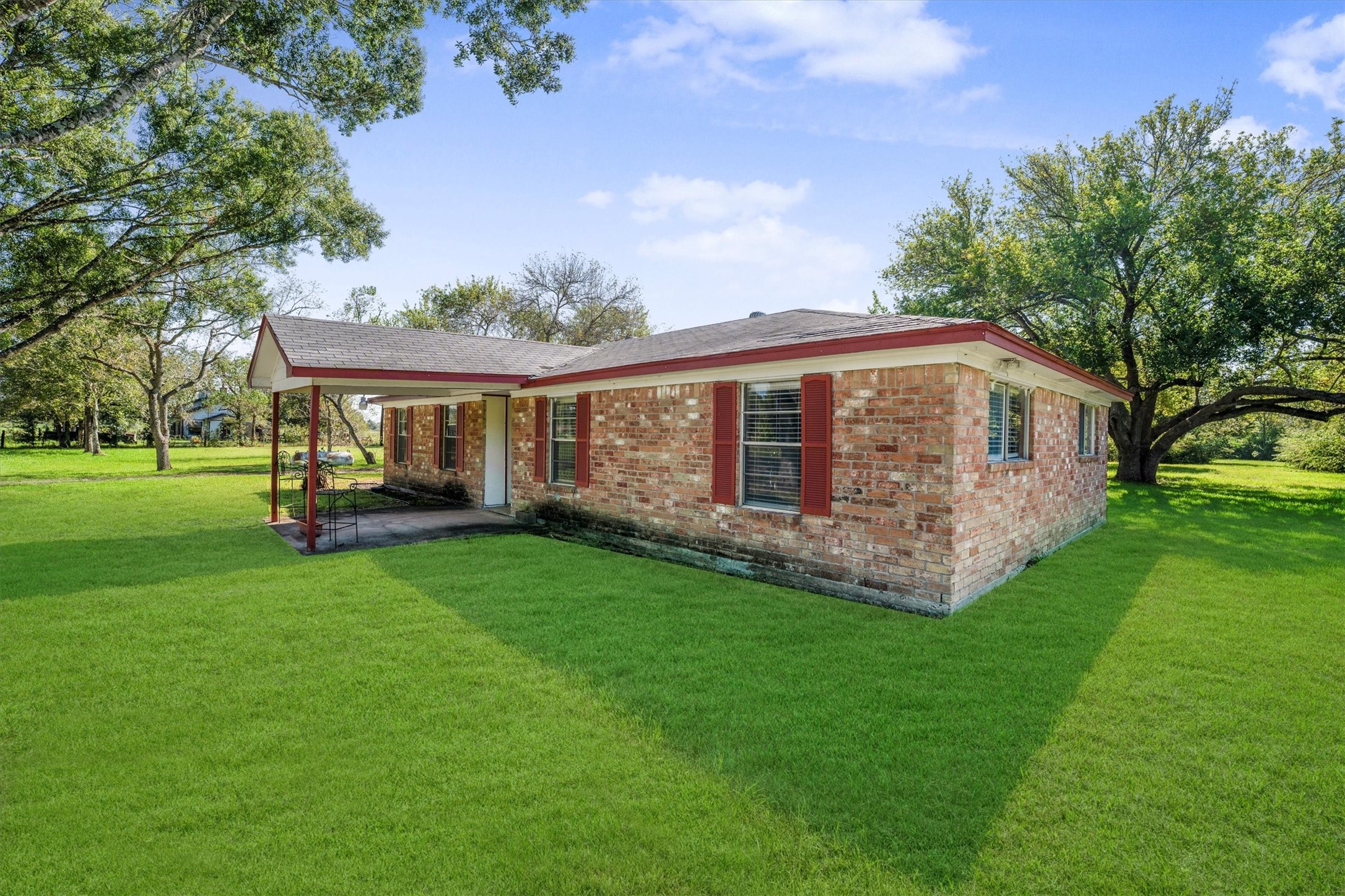 18111 Roy Long Road Pearland, TX 77584 - Photo 3 of 36 The covered front porch invites you to slow down, sit awhile, and enjoy the quiet country breeze.