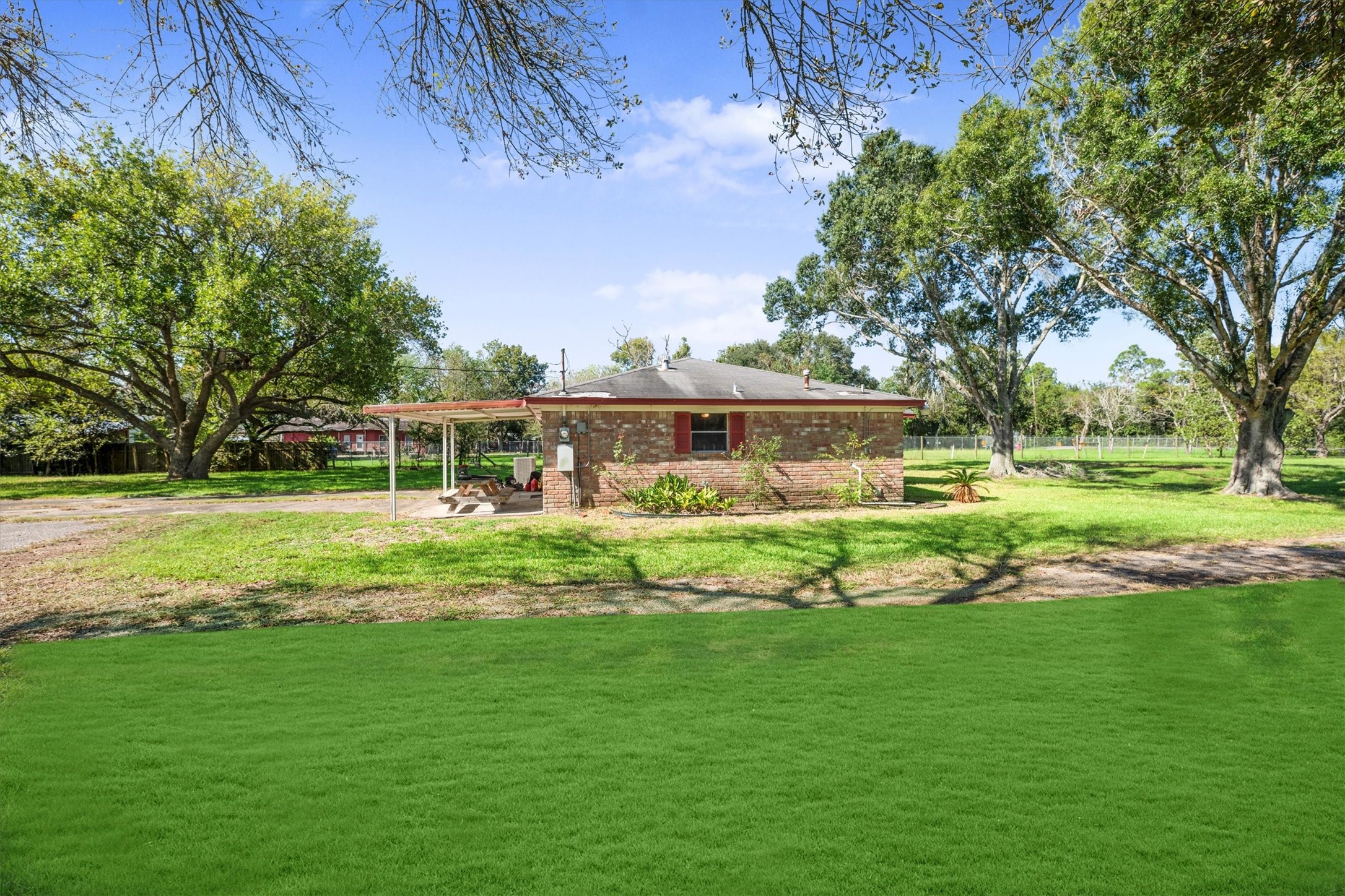 18111 Roy Long Road Pearland, TX 77584 - Photo 32 of 36 The home’s brick exterior and covered patio offer a perfect spot for outdoor dining or relaxing in the shade.