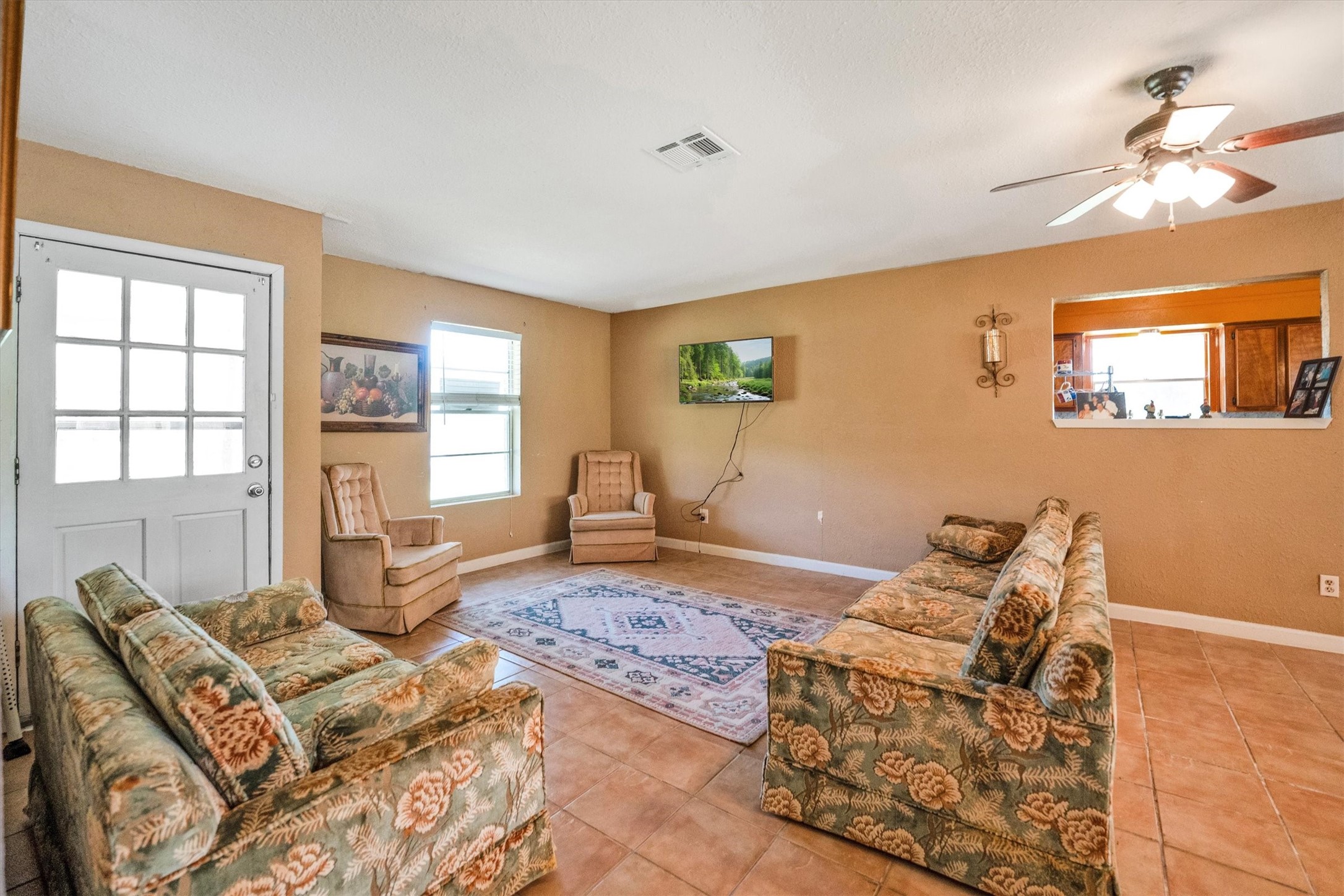 18111 Roy Long Road Pearland, TX 77584 - Photo 7 of 36 Classic tile floors and warm tones make this room feel inviting and easy to maintain—perfect for family time or quiet evenings.
