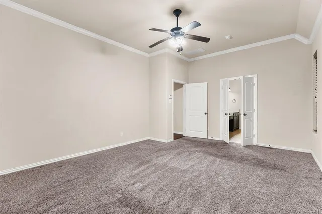 a view of an empty room with a ceiling fan