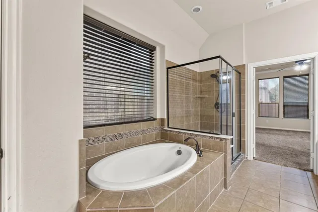 a bathroom with a bathtub and a shower