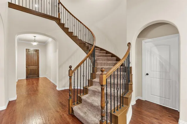 a view of entryway with wooden floor and stairs