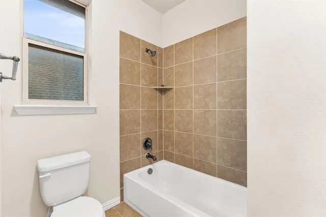 a bathroom with a toilet and a bathtub