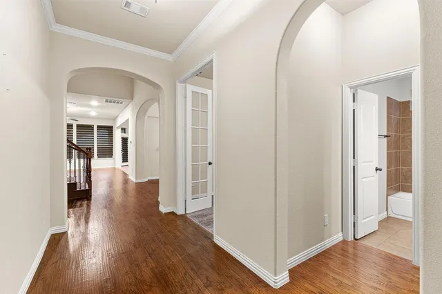 a view of a hallway with wooden floor
