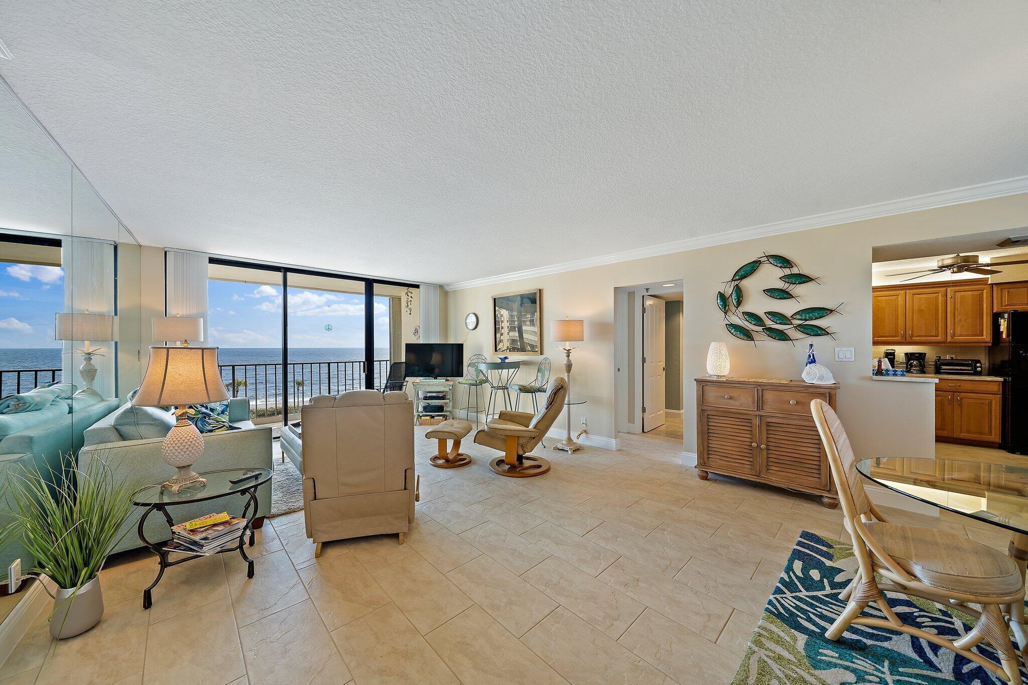 100 Ocean Trail Way, Unit 609 Jupiter, FL 33477 - Photo 4 of 66 a living room with furniture gym equipment and a large window