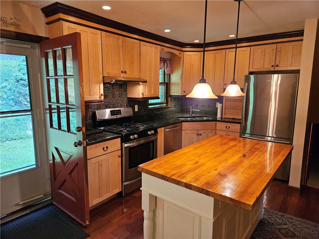 207 College Lodge Road Indiana, PA 15701 - Photo 13 of 36 a kitchen with stainless steel appliances granite countertop a stove top oven a sink dishwasher and a refrigerator with wooden floor