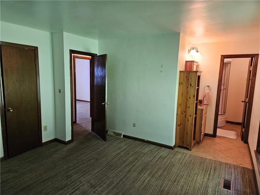 207 College Lodge Road Indiana, PA 15701 - Photo 18 of 36 an empty room with wooden floor and closet