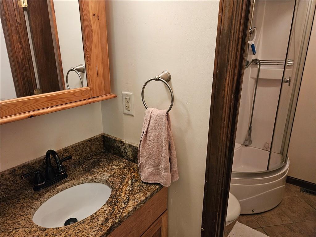 207 College Lodge Road Indiana, PA 15701 - Photo 19 of 36 a bathroom with a granite countertop sink and a mirror