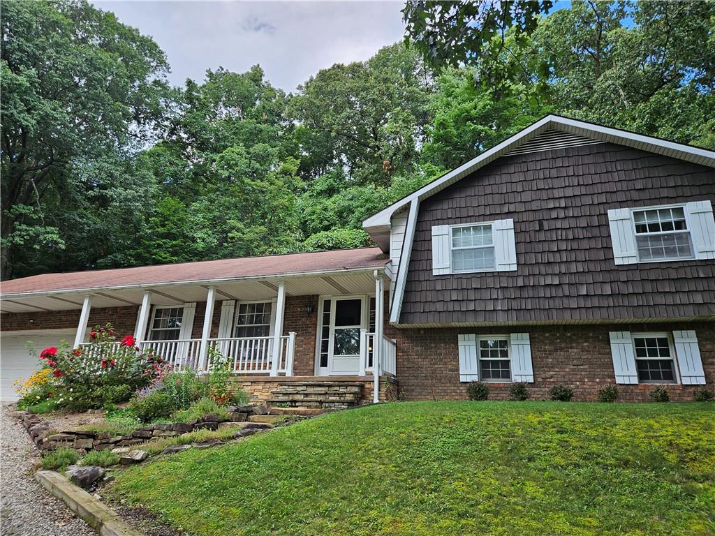 207 College Lodge Road Indiana, PA 15701 - Photo 2 of 36 a view of a house with a yard potted plants and a table