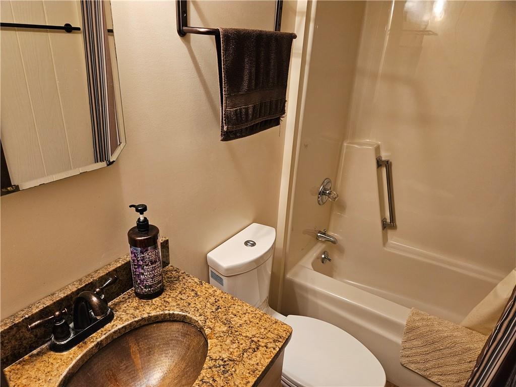 207 College Lodge Road Indiana, PA 15701 - Photo 24 of 36 a bathroom with a granite countertop toilet sink and mirror