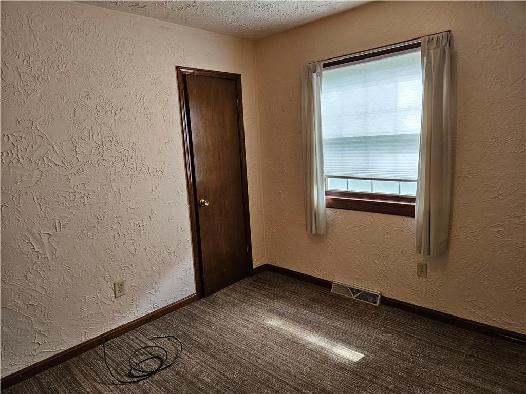 207 College Lodge Road Indiana, PA 15701 - Photo 25 of 36 an empty room with wooden floor and mirror