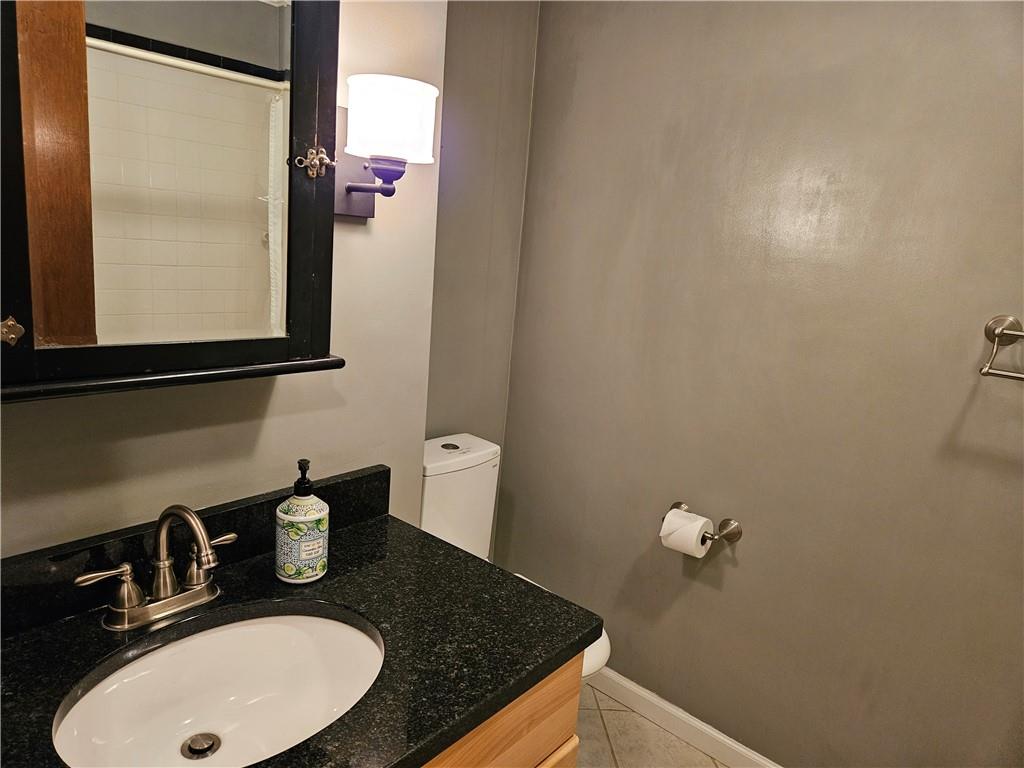 207 College Lodge Road Indiana, PA 15701 - Photo 31 of 36 a bathroom with a granite countertop sink and a mirror
