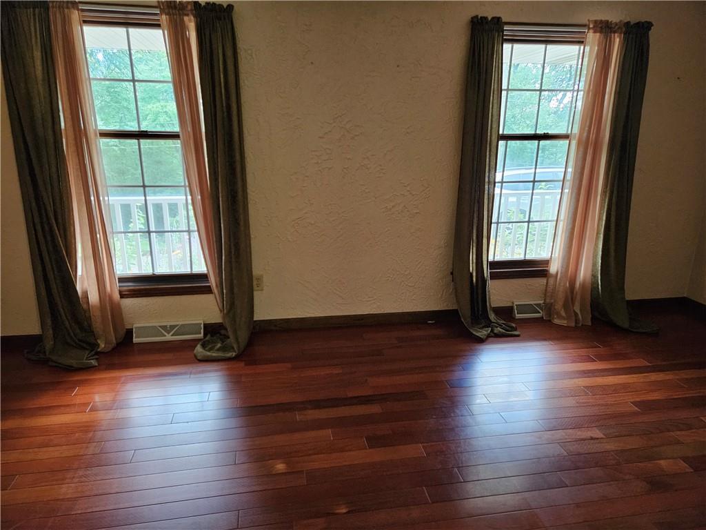 207 College Lodge Road Indiana, PA 15701 - Photo 9 of 36 an empty room with wooden floor and windows